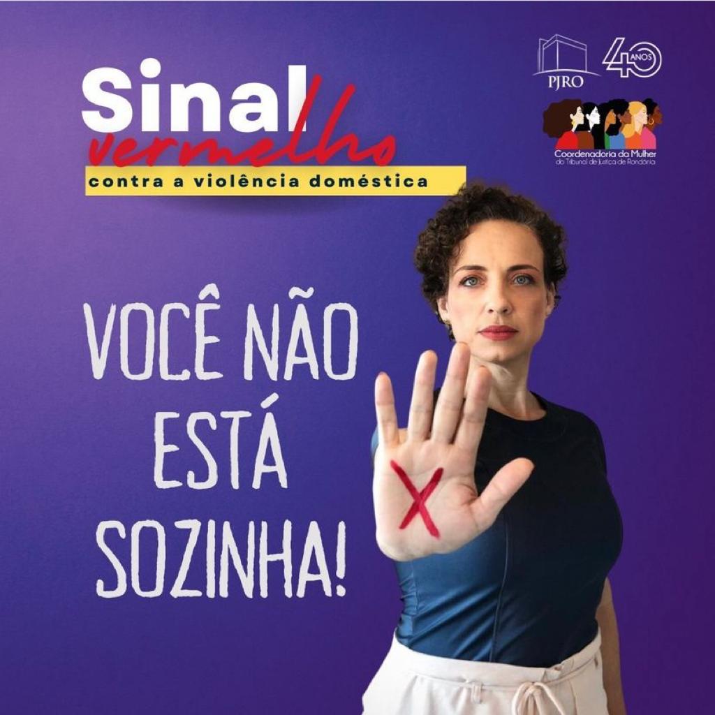 Arte da campanha com fundo lilás e foto de uma mulher com sinal de x vermelho na palma da mão.